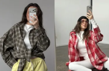 Two women pose in mirror selfies wearing oversized plaid shirts and white outfits; left in grey plaid with yellow pants, right in red plaid with white pants.